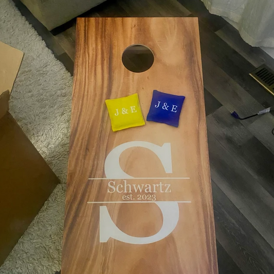 cornhole board with personalized J&E bean