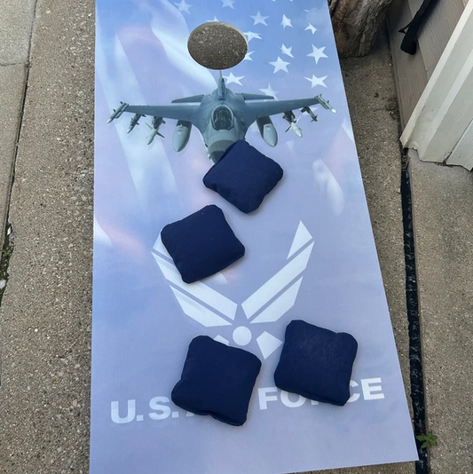 Cornhole board with blue bags, jet, and US Air Force text