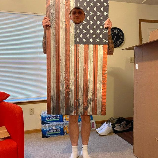 kid holding cornhole boards