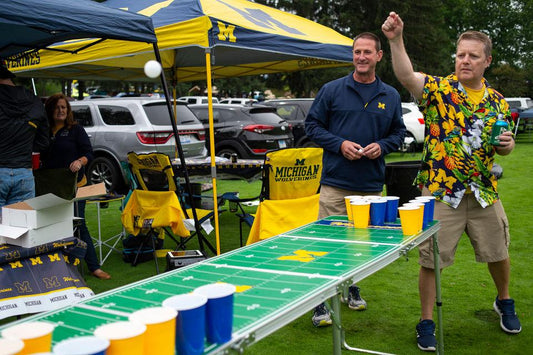 playing beer pong at a tailgate party