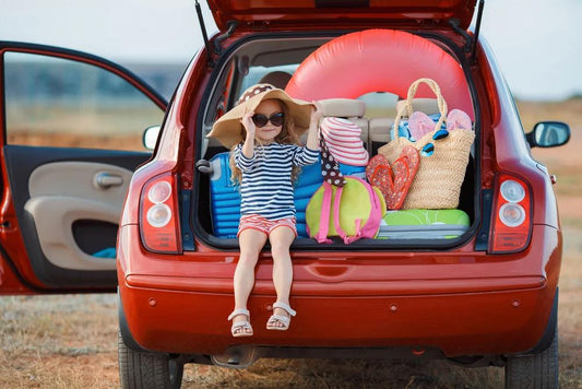 daughter sitting outside packed car