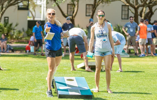 girls learning cornhole