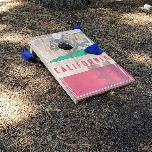 cornhole bags on the board