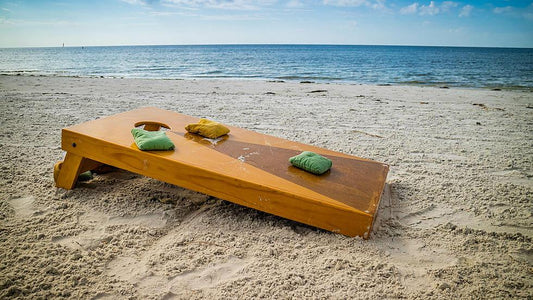 cornhole game on the beach