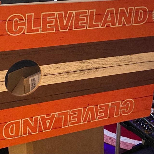 cornhole board with orange, brown