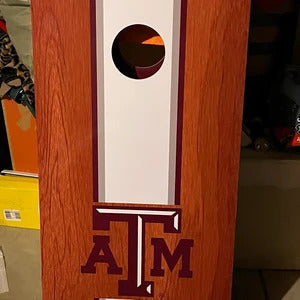 wood grain cornhole board with a white center stripe