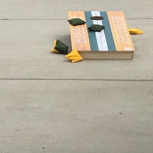 Custom cornhole board that reads 'Green Bay'.