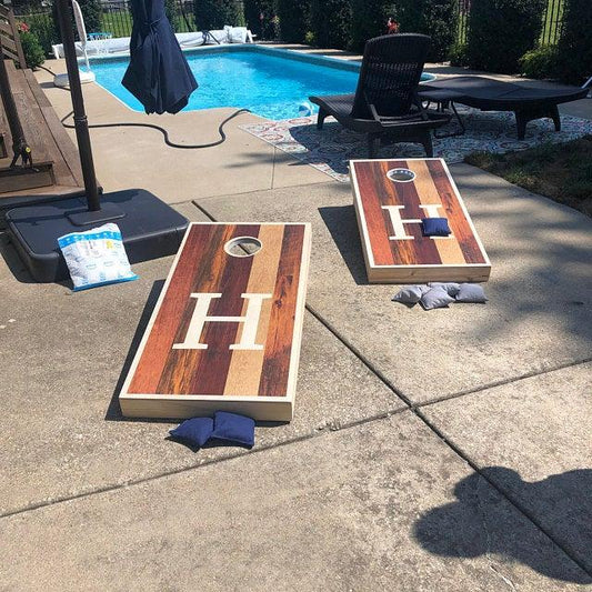 Monogrammed letter H multi-toned wood grain cornhole boards
