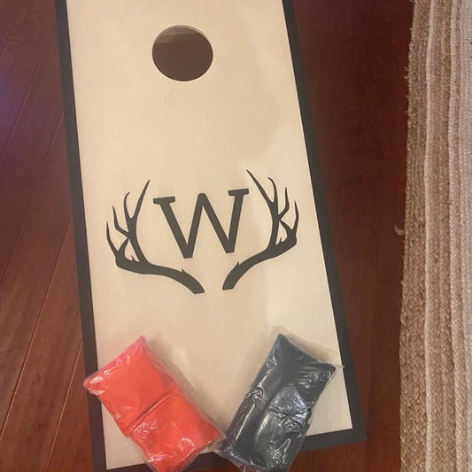 Personalized cornhole set featuring antler initial