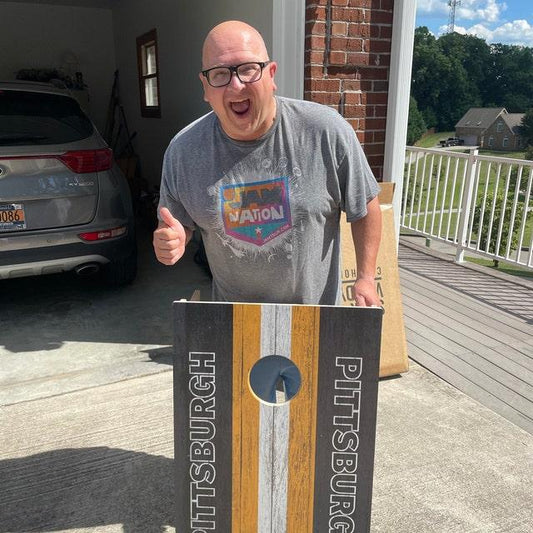 happy guy after winning at cornhole
