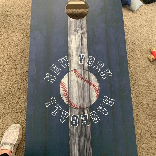 cornhole board with a baseball graphic