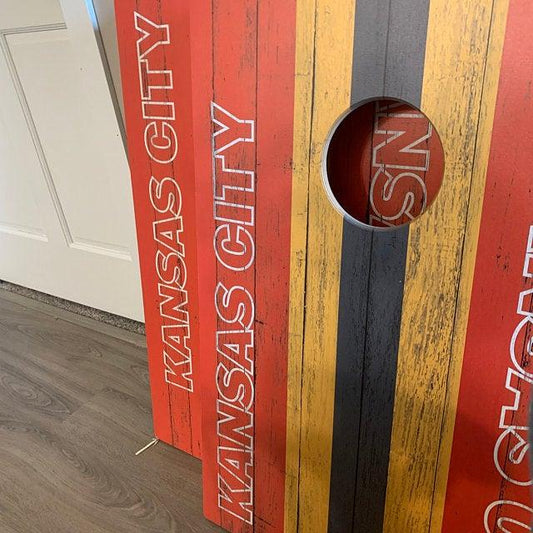 Football fan cornhole board in red, gold, and black team colors
