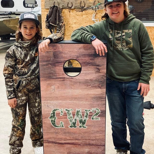 young kids enjoying cornhole