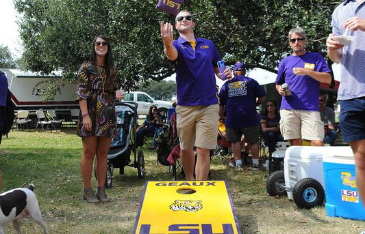 playing cornhole at lsu tailgate party