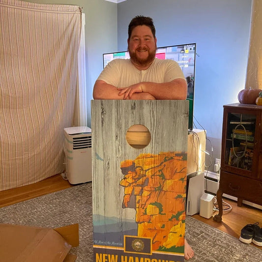 Man holding cornhole board