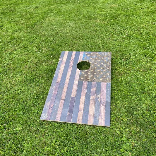 cornhole board in the grass