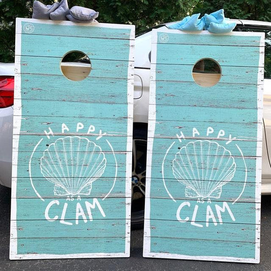 Pair of distressed teal wood cornhole boards with "Happy as a Clam"