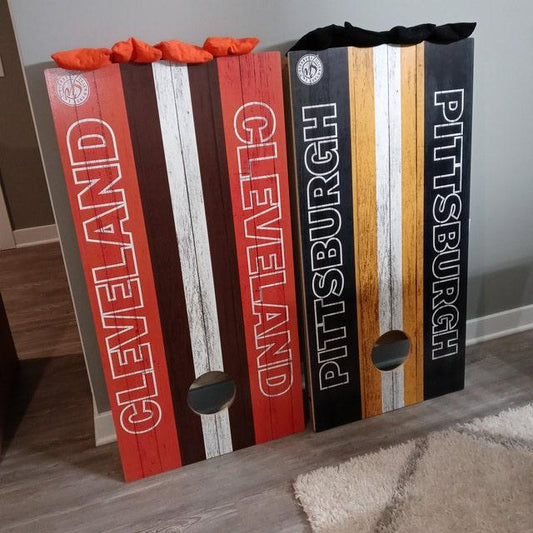 Cleveland and Pittsburgh themed cornhole boards with bean bags